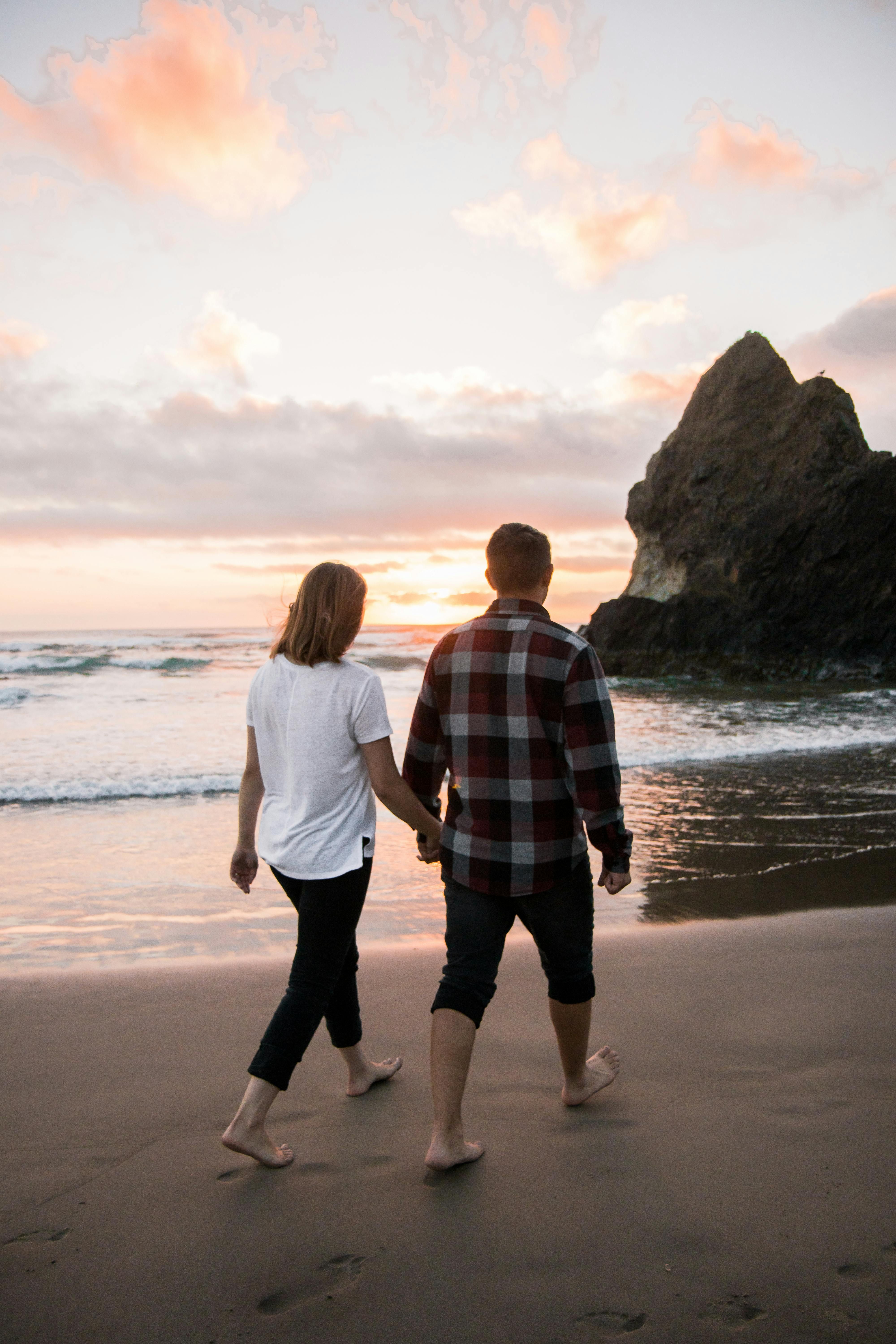 Couple embracing while looking toward the sea